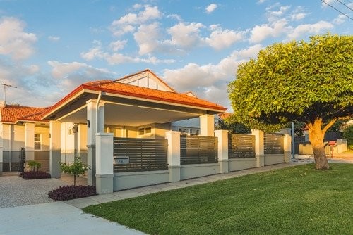 Contemporary carport with fence