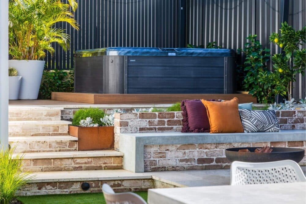 Spa landscaping with paved staircase and retaining walls